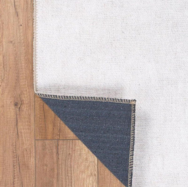 Close-up of the Artistic Splash Rug’s colorful, low-profile pile design