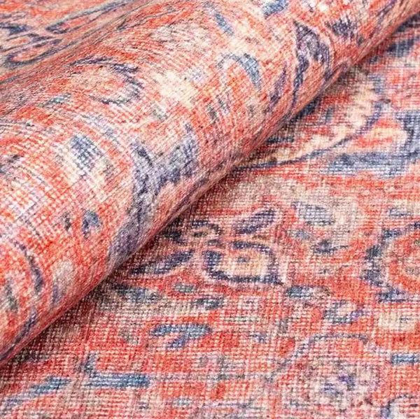 Close-up of the intricate floral designs on the luxurious pink Persian rug.